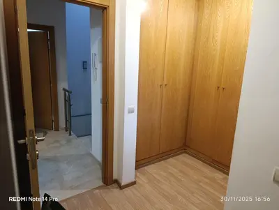 an empty hallway with wooden cabinets and a door at Océane palm in Casablanca