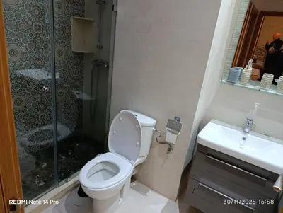 a bathroom with a toilet and a shower and a sink at Océane palm in Casablanca