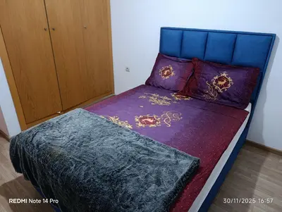 a bedroom with a bed with purple sheets and pillows at Océane palm in Casablanca