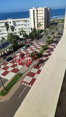 a street with a red and white checkered sidewalk at Bonheur Au bord de la mère in Casablanca