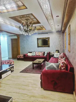 a living room with couches and a chandelier at Bonheur Au bord de la mère in Casablanca