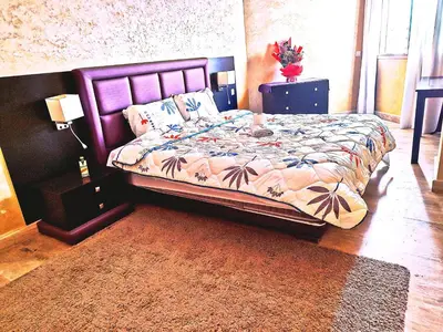 a bedroom with a bed with a purple headboard at Bonheur Au bord de la mère in Casablanca