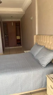 a bedroom with a large bed with a large window at Appartement de standing au cœur du quartier historique des Habous in Casablanca