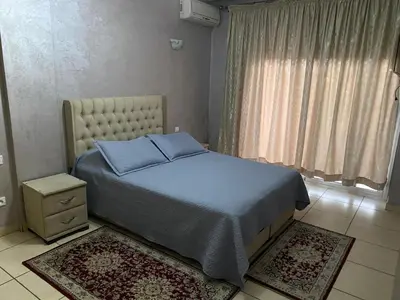 a bedroom with a bed and a window and rugs at Appartement de standing au cœur du quartier historique des Habous in Casablanca