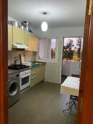 a kitchen with a stove and a washing machine at Appartement de standing au cœur du quartier historique des Habous in Casablanca