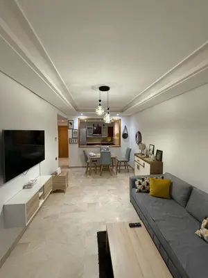 a living room with a gray couch and a table at Lovely place in Casablanca