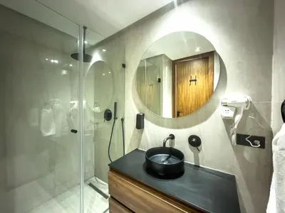 a bathroom with a sink and a mirror at Modern, Fully Equipped Studio Just Steps from Mohammed 5 Stadium, Maarif in Casablanca