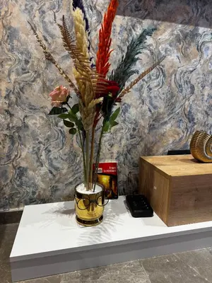 a vase with flowers in it sitting on a table at Modern, Fully Equipped Studio Just Steps from Mohammed 5 Stadium, Maarif in Casablanca