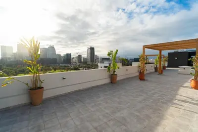a balcony with potted plants and a view of a city at Modern & chic studio in Anfa Park, Fast Wifi in Casablanca