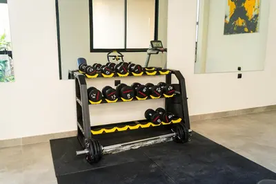 a rack filled with lots of dumbbells in a room at Modern & chic studio in Anfa Park, Fast Wifi in Casablanca