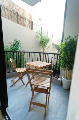 a patio with a table and chairs on a balcony at Modern & chic studio in Anfa Park, Fast Wifi in Casablanca