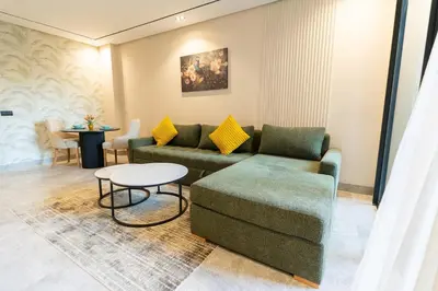a living room with a couch and a table at Modern & chic studio in Anfa Park, Fast Wifi in Casablanca