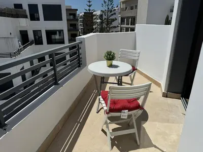 two chairs and a table on a balcony at Modern, Fully Equipped Studio Close to Mohamed 5 Stadium - Maarif in Casablanca
