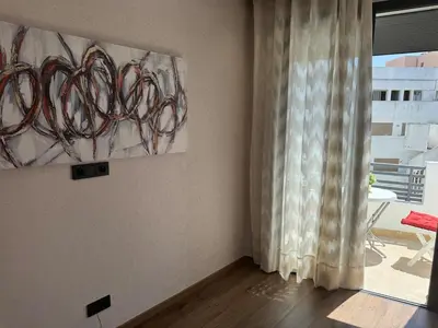 a living room with a painting and a window at Modern, Fully Equipped Studio Close to Mohamed 5 Stadium - Maarif in Casablanca