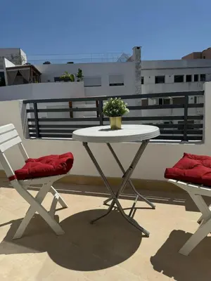 a white table and two chairs on a balcony at Modern, Fully Equipped Studio Close to Mohamed 5 Stadium - Maarif in Casablanca