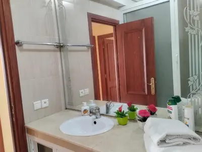 a bathroom with a sink and a large mirror at Appartament a 2 minute de la mer et la mosquee Hassan 2 in Casablanca-Port