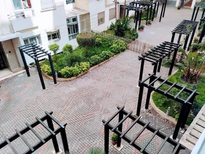 a group of benches sitting in a courtyard at Appartament a 2 minute de la mer et la mosquee Hassan 2 in Casablanca-Port