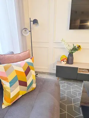a living room with a colorful pillow and a table at Casablanca METROPOL Suites in Casablanca