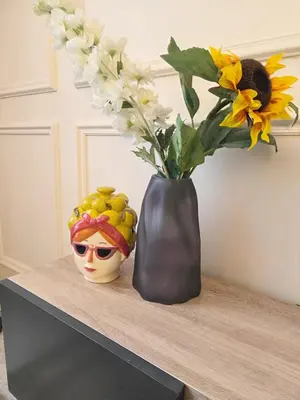 a vase with flowers and a vase with a vase at Casablanca METROPOL Suites in Casablanca
