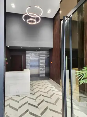 an office lobby with a glass door and a chandelier at Casablanca METROPOL Suites in Casablanca