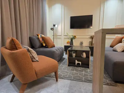 a living room with a couch and a chair at Casablanca METROPOL Suites in Casablanca