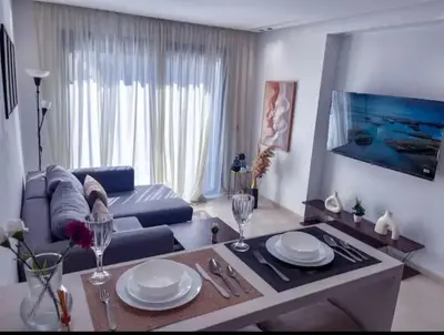 a living room with a couch and a table at Sleek Modern Studio with Plenty of Light in Casablanca