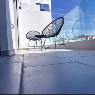 a pair of chairs sitting on the side of a building at Sleek Modern Studio with Plenty of Light in Casablanca