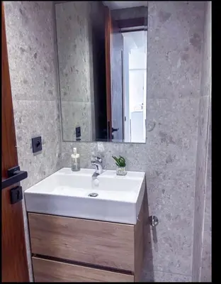 a bathroom with a white sink and a mirror at Sleek Modern Studio with Plenty of Light in Casablanca