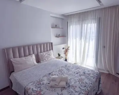 a bedroom with a large bed with a large window at Sleek Modern Studio with Plenty of Light in Casablanca