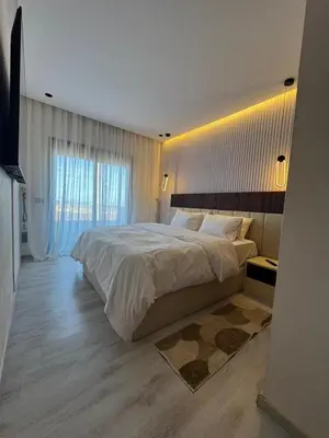 a bedroom with a large bed and a window at High standing 2 bedroom apartment in Casablanca