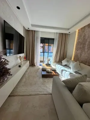 a living room with a couch and a tv at High standing 2 bedroom apartment in Casablanca