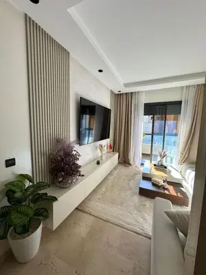 a living room with a couch and a tv at High standing 2 bedroom apartment in Casablanca