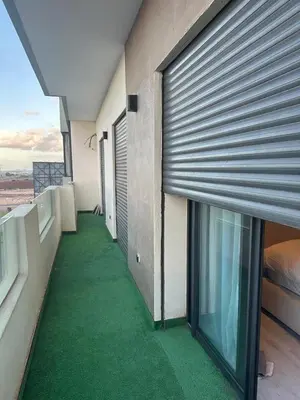 a balcony with green flooring in a building at High standing 2 bedroom apartment in Casablanca