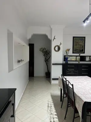 a kitchen and dining room with a table and chairs at Athènes résidence in Océan
