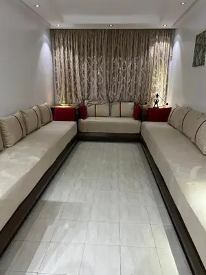 a living room with two long couches in front of a window at Athènes résidence in Océan