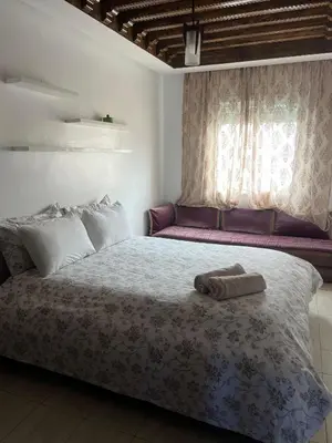 a bedroom with a bed with a towel on it at Athènes résidence in Océan