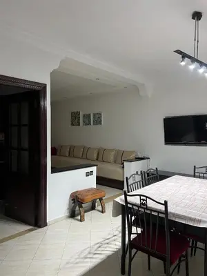 a living room with a table and a couch at Athènes résidence in Océan