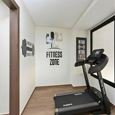 a gym with a treadmill and a fitness zone at ORA Luxoria Suite Racine & Gym by Staycationcasa in Casablanca-Port