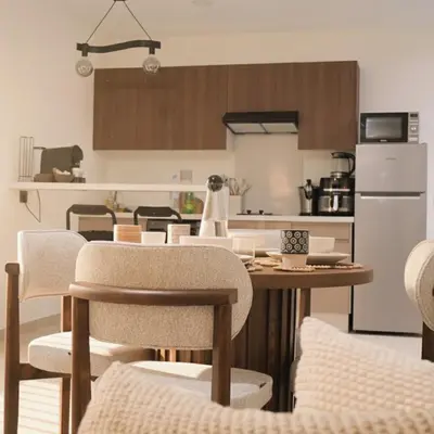 a kitchen with a table and chairs and a refrigerator at ORA Luxoria Suite Racine & Gym by Staycationcasa in Casablanca-Port