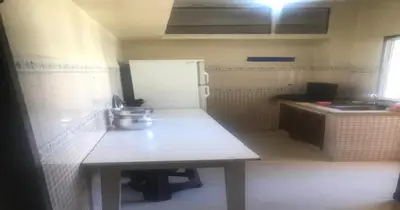 a small kitchen with a table and a sink at Bon repos in Casablanca