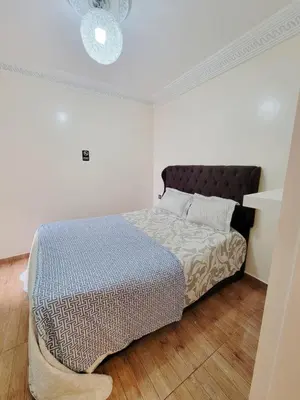 a bedroom with a bed in a white room at 7 min to beach luxury apartment Dar Bouazza in Casablanca