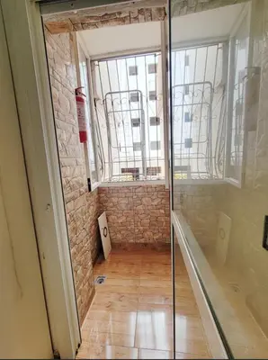 a glass door in a room with a brick wall at 7 min to beach luxury apartment Dar Bouazza in Casablanca