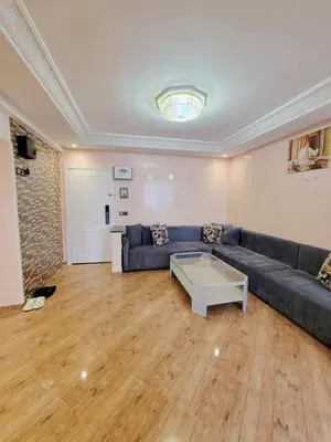 a living room with a couch and a table at 7 min to beach luxury apartment Dar Bouazza in Casablanca