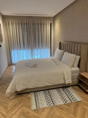 a bedroom with a large white bed with a window at Selena Modern Studio with Quick Access to Tramway near to Mohamed 5 Stadium in Casablanca in Casablanca