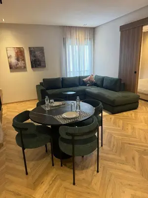 a living room with a couch and a table at Selena Modern Studio with Quick Access to Tramway near to Mohamed 5 Stadium in Casablanca in Casablanca