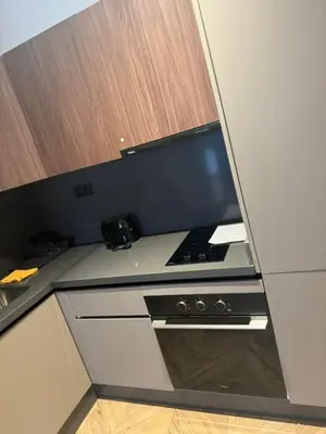 a small kitchen with a desk with a computer on it at Selena Modern Studio with Quick Access to Tramway near to Mohamed 5 Stadium in Casablanca in Casablanca