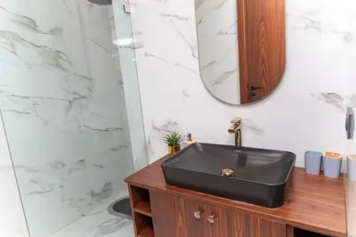 a bathroom with a black sink and a mirror at Peaceful Haven for a Quiet Stay in Maarif 500m to Mohamed Stadium in Casablanca