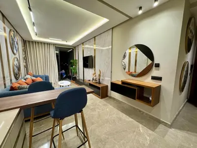 a living room with a blue couch and a mirror at SALVia Loft - Sweetness and Cozy Apartment with Terrace Near Mohammed V Stadium in Casablanca