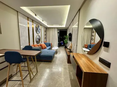 a living room with a blue couch and a mirror at SALVia Loft - Sweetness and Cozy Apartment with Terrace Near Mohammed V Stadium in Casablanca