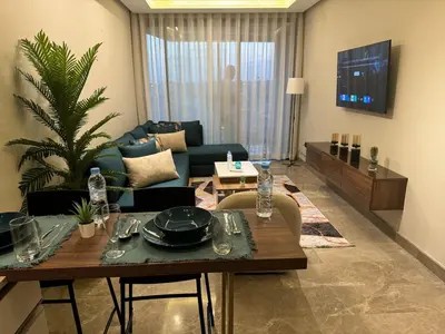 a living room with a table and a couch at HERBA Studio - Cozy Space with an Unobstructed View in Bourgogne in Casablanca